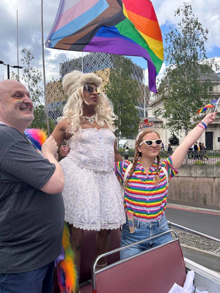 People waving flags at Pride