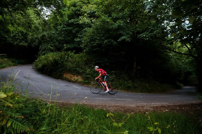 Someone cycling on a country road