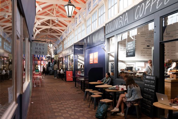 People sitting at a coffee shop in Oxford Covered Market
