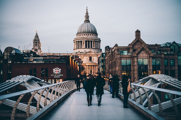 People walking across Millennium Bridge to St Paul's Cathedral