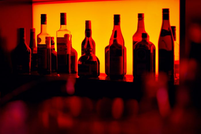 A collection of drinks with an orange background