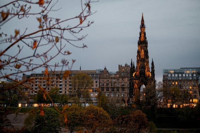 A view of Edinburgh’s Scott Monument from behind a tree in Autumn.