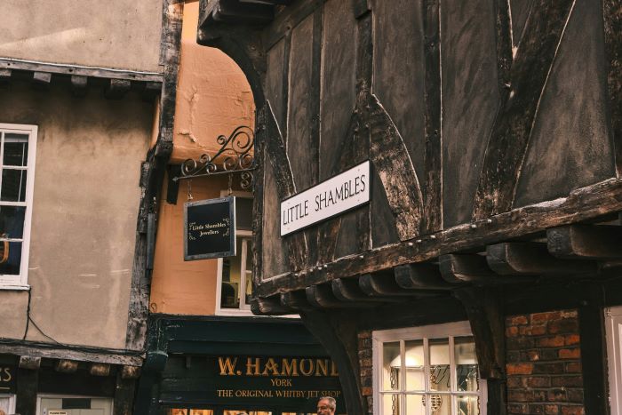 A sign saying 'Little Shambles' in a street