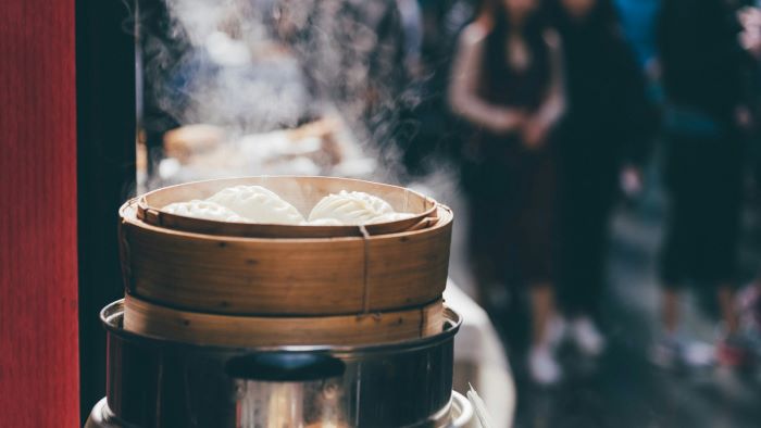 A bamboo steamer holding dumplings.