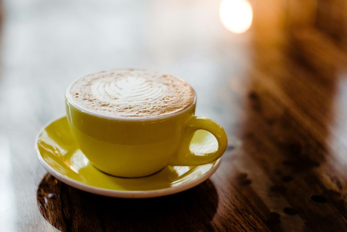 A yellow coffee mug in a cafe